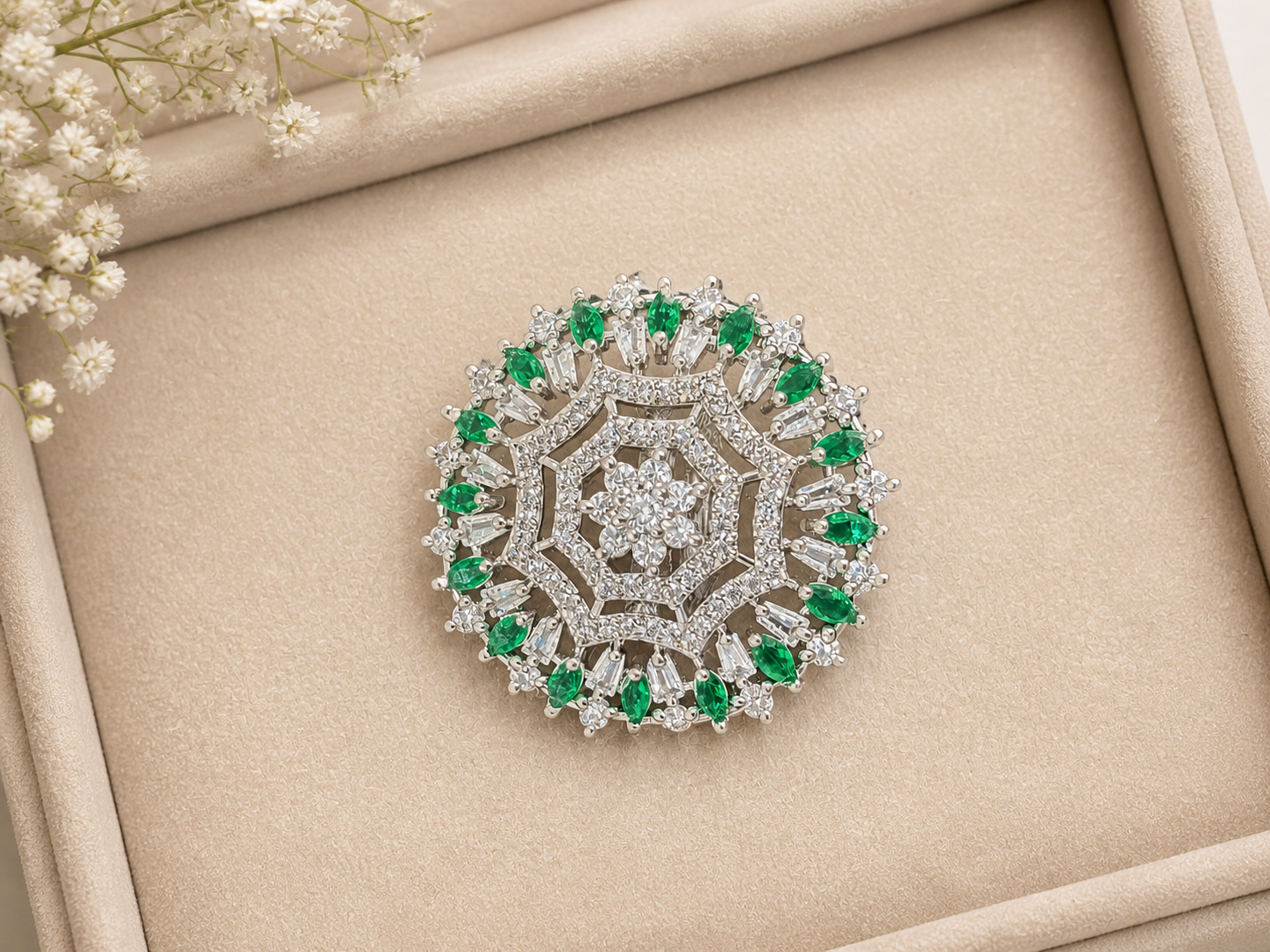 Stunning Ring, intricately crafted brooch with floral motif and sparkling clear and emerald stones.
