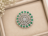 Stunning Ring, intricately crafted brooch with floral motif and sparkling clear and emerald stones.