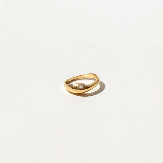 Women’s gold Bracelet featuring a diamond accent, elegant and stylish ring on a light background.