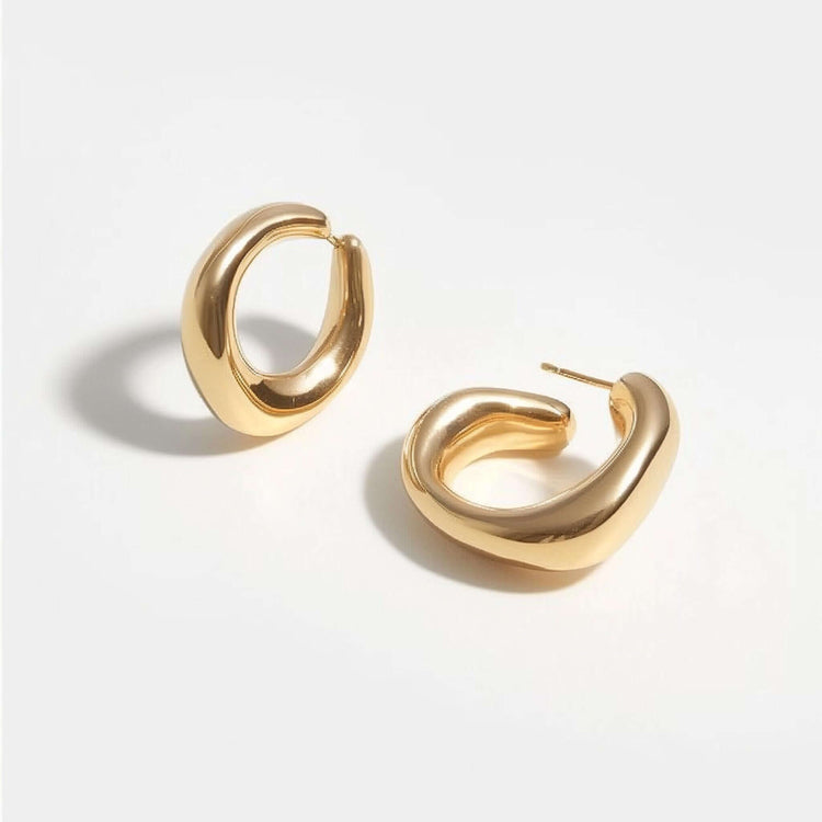 Gold Chunky Hoop Earrings displayed on a light background, showcasing their glossy finish and unique chunky design.